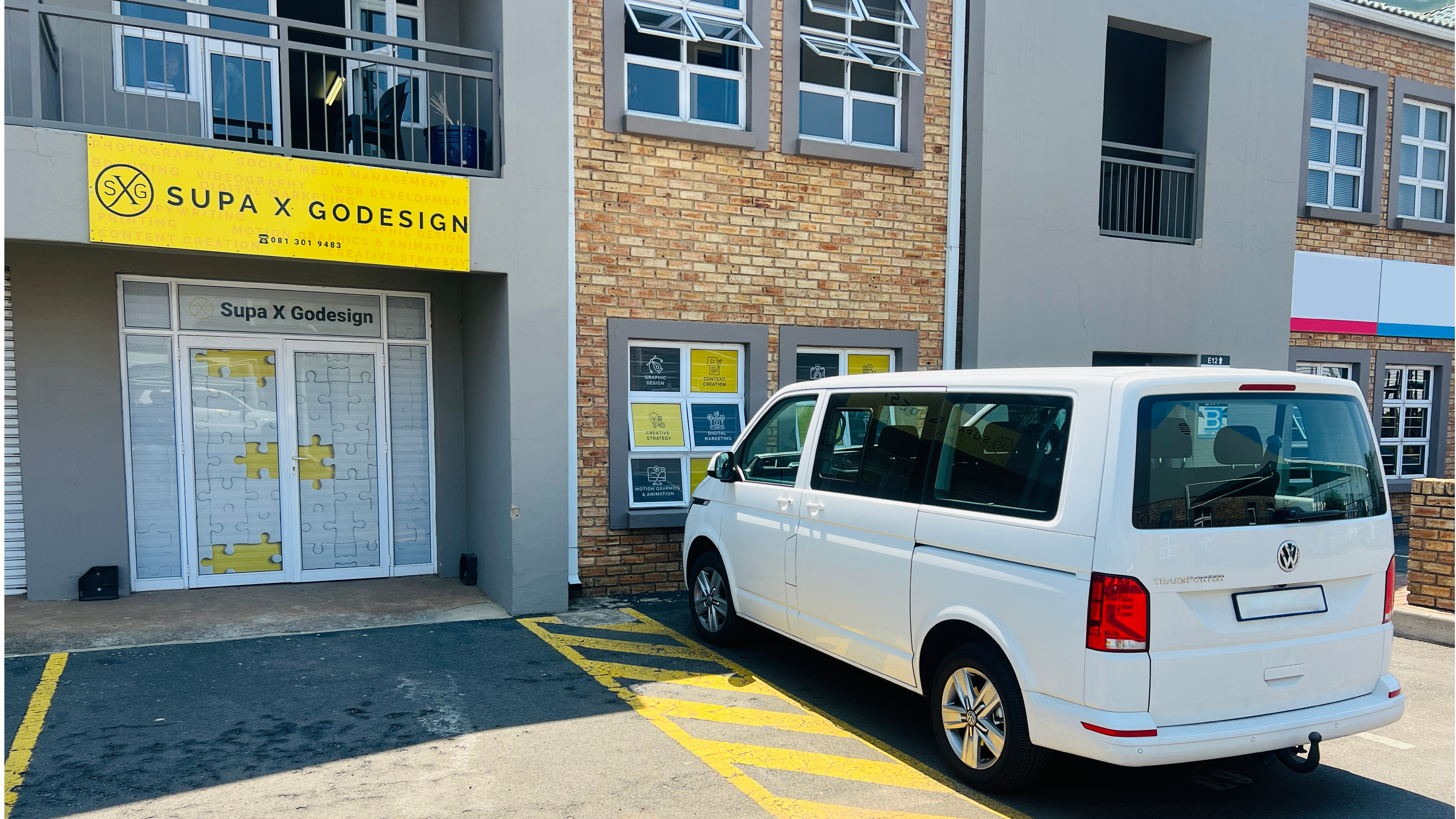 Supa X Godesign office frontage with branded signage and vehicle.